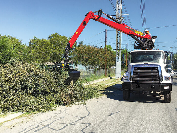 Grapple Service truck on a residential street lined with palm trees